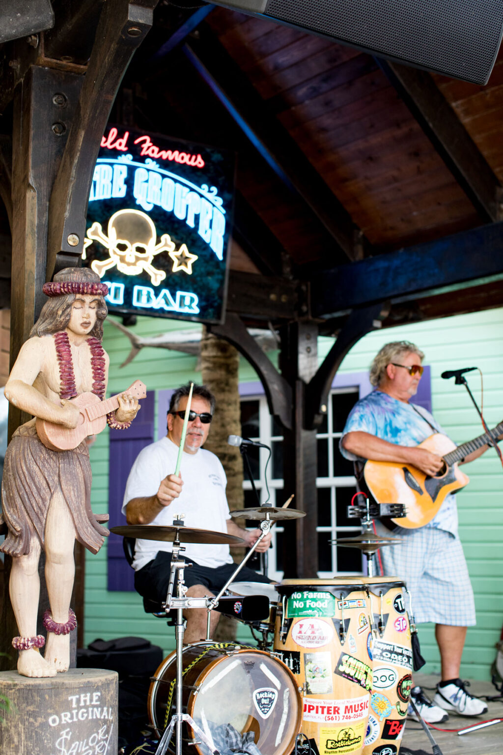 A band performing on stage at the World Famous Square Grouper Tiki Bar